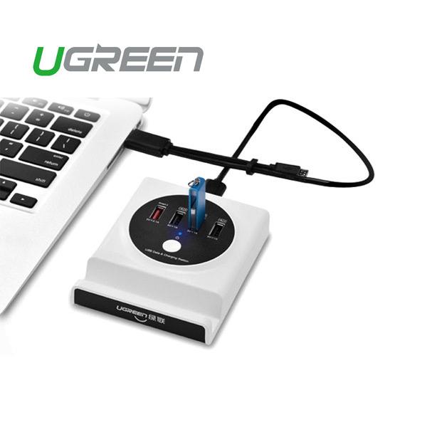UGREEN USB hub connected to a laptop on a white background