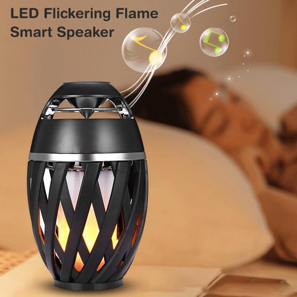 LED flickering flame smart speaker on a wooden surface with a blurred background