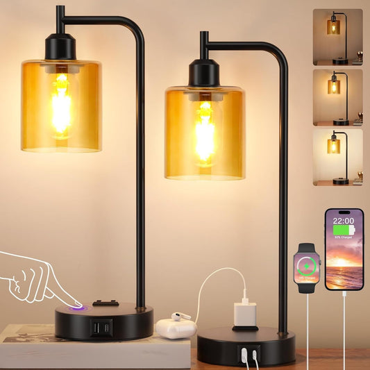Modern table lamp with glass shades and USB ports, shown on a desk with smartphone and accessories.