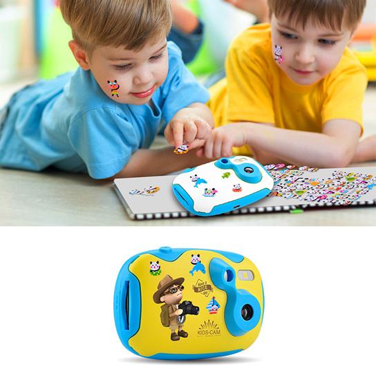 Two children playing with a toy camera on a table.