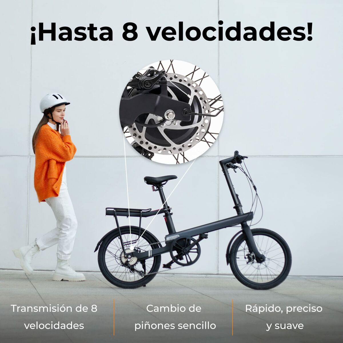 Person with a helmet standing next to an electric bike with a close-up of the gear system on a light gray background.