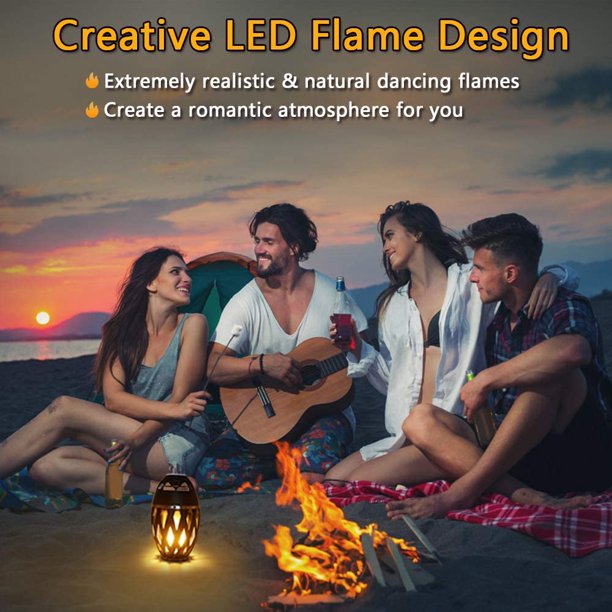 People sitting around a fire with a Creative LED Flame Design product, set against a sunset backdrop.