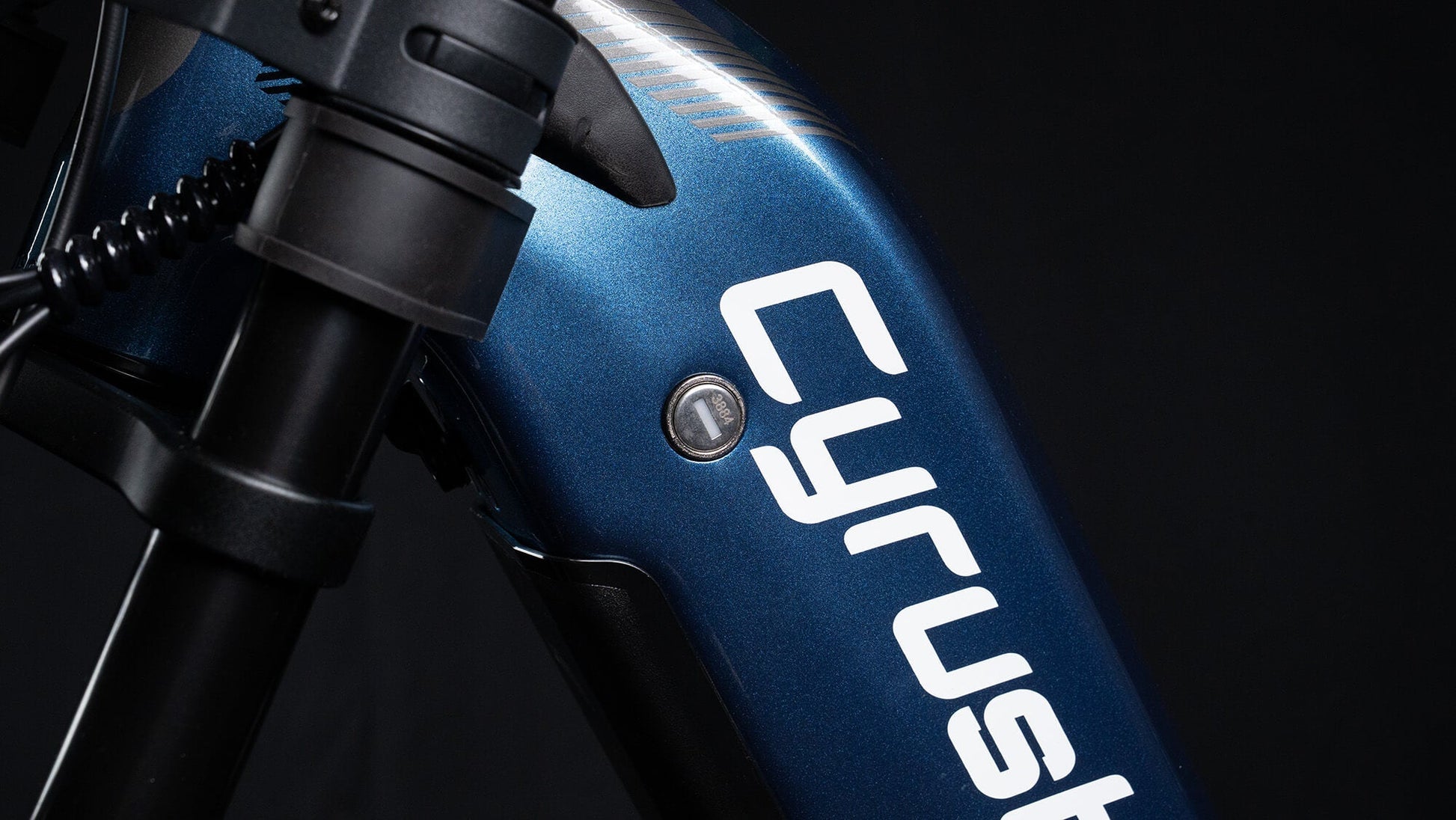 Close-up of a blue bicycle with 'Cyrusher' branding on a black background