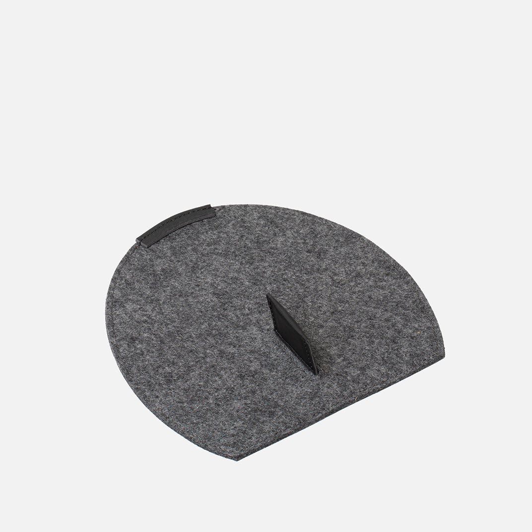 Gray cushion with a black triangular cutout on a light gray background