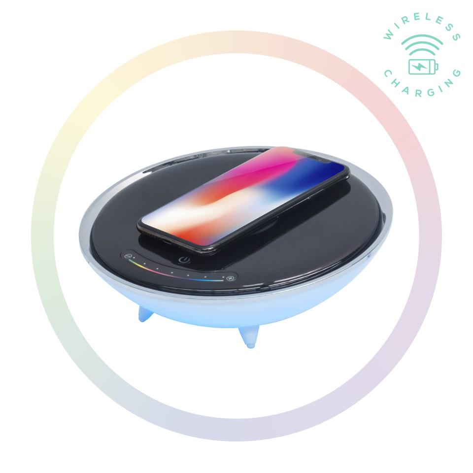 Wireless charging pad with a smartphone on a white background. Axis-Dynamics