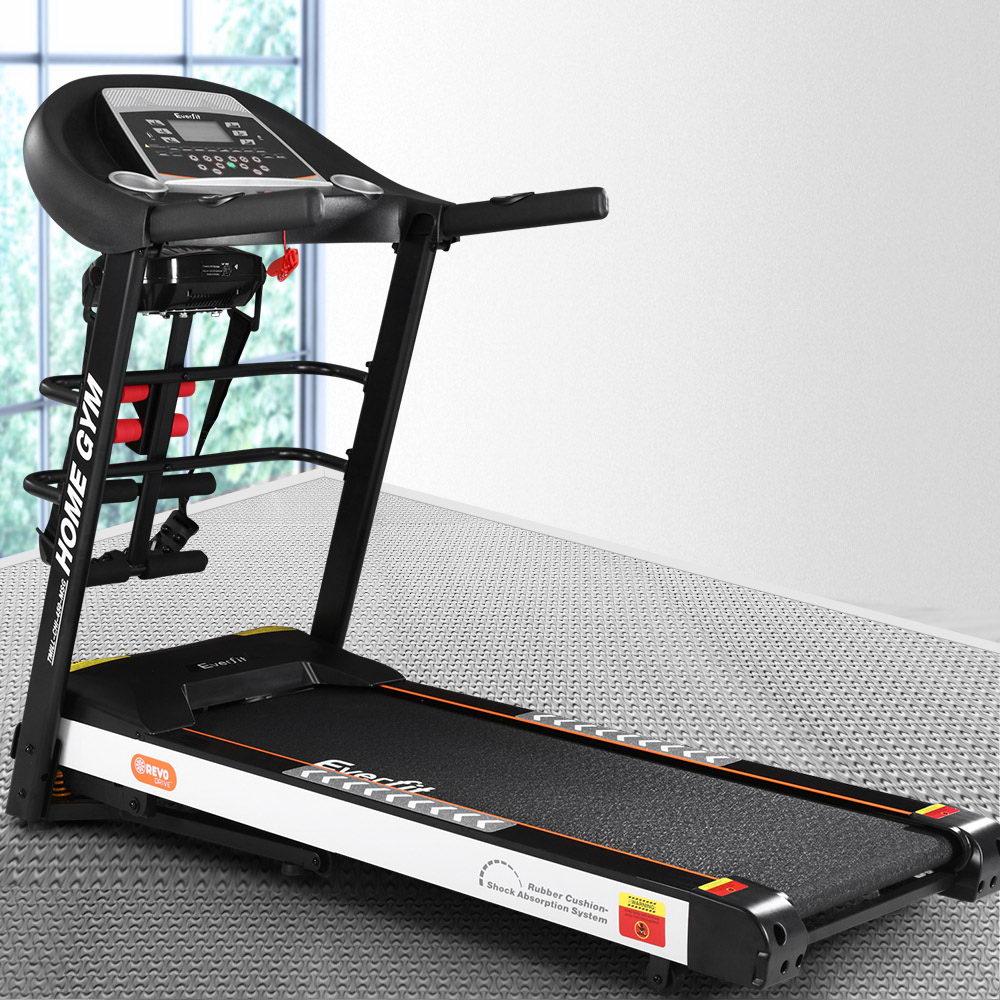 Treadmill with digital display on a gray floor with a window in the background