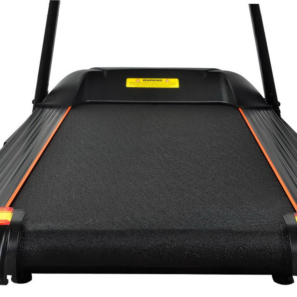 Black treadmill with orange trim on a white background