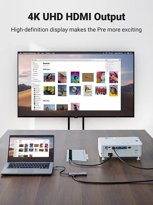 4K UHD HDMI Output setup with laptop, monitor, and projector on a wooden surface.