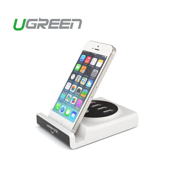 Phone on a charging stand with UGREEN branding on a white background