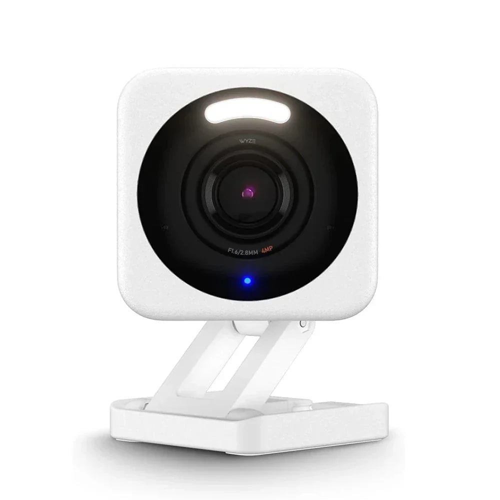 White security camera with black lens on a white background