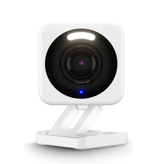 White security camera with black lens on a white background
