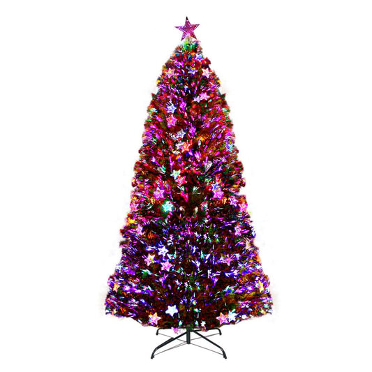 A decorated artificial Christmas tree on a black metal stand, covered in colorful tinsel and star ornaments, with multicolored string lights, isolated on a white background.