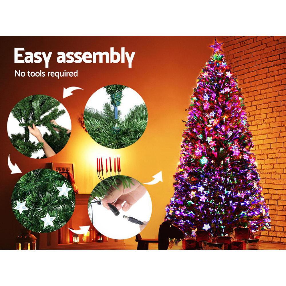 A lit artificial Christmas tree with colorful star-shaped lights stands in a room with a brick wall background. The left side includes marketing text reading 'Easy assembly' and 'No tools required,' plus four circular inset photos showing close-up assembly steps.