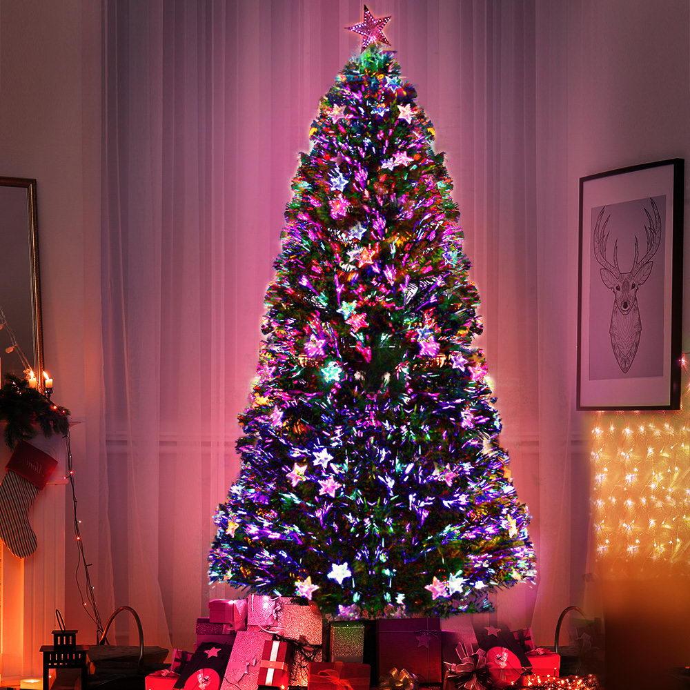 Decorated Christmas tree with colorful lights in a room setting.