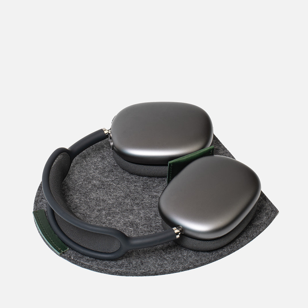 Pair of gray headphones with a carrying case on a light gray background