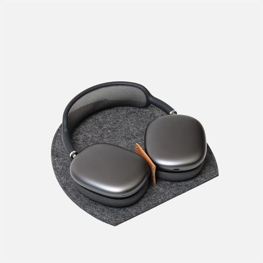 Black headphones on a gray cushion with a white background