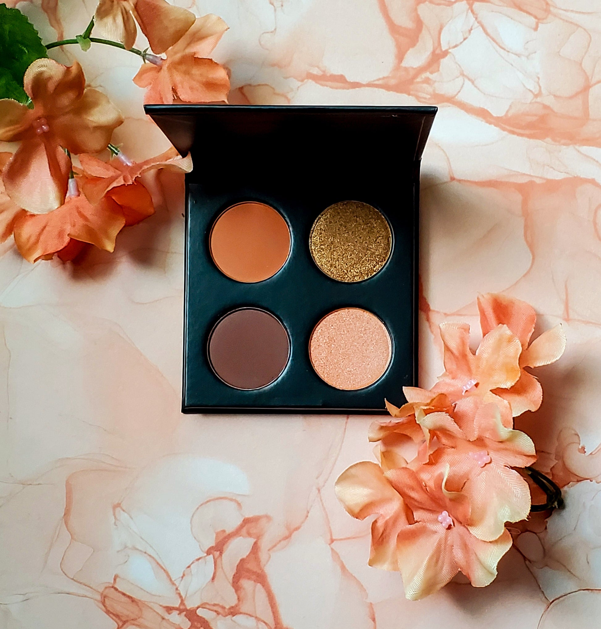 Makeup palette with four colors on a floral background. Best online retail store. Axis-Dynamics