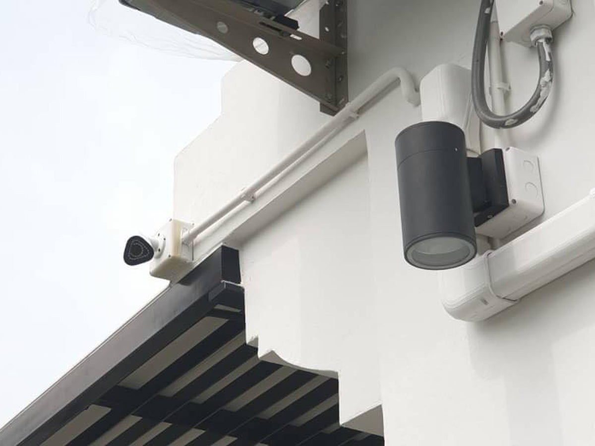 Security camera and lights on a building exterior