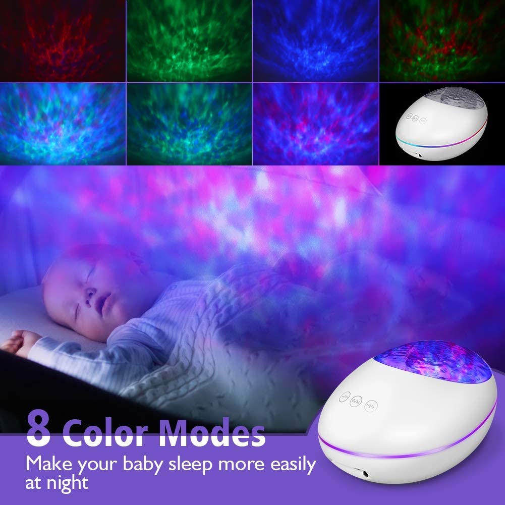 Baby sleeping with a colorful light projector in the background