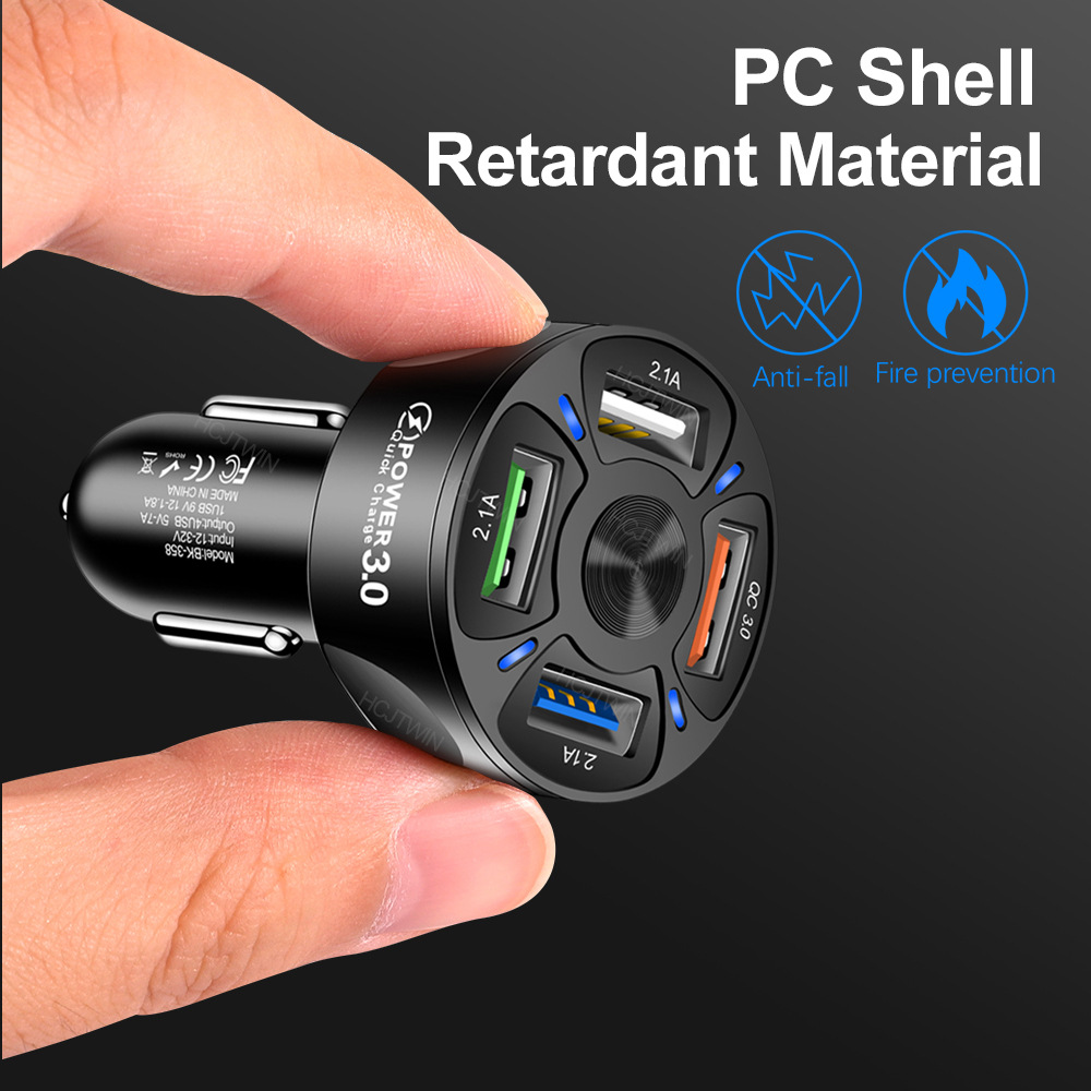 Car charger with multiple USB ports held by a hand, against a black background.