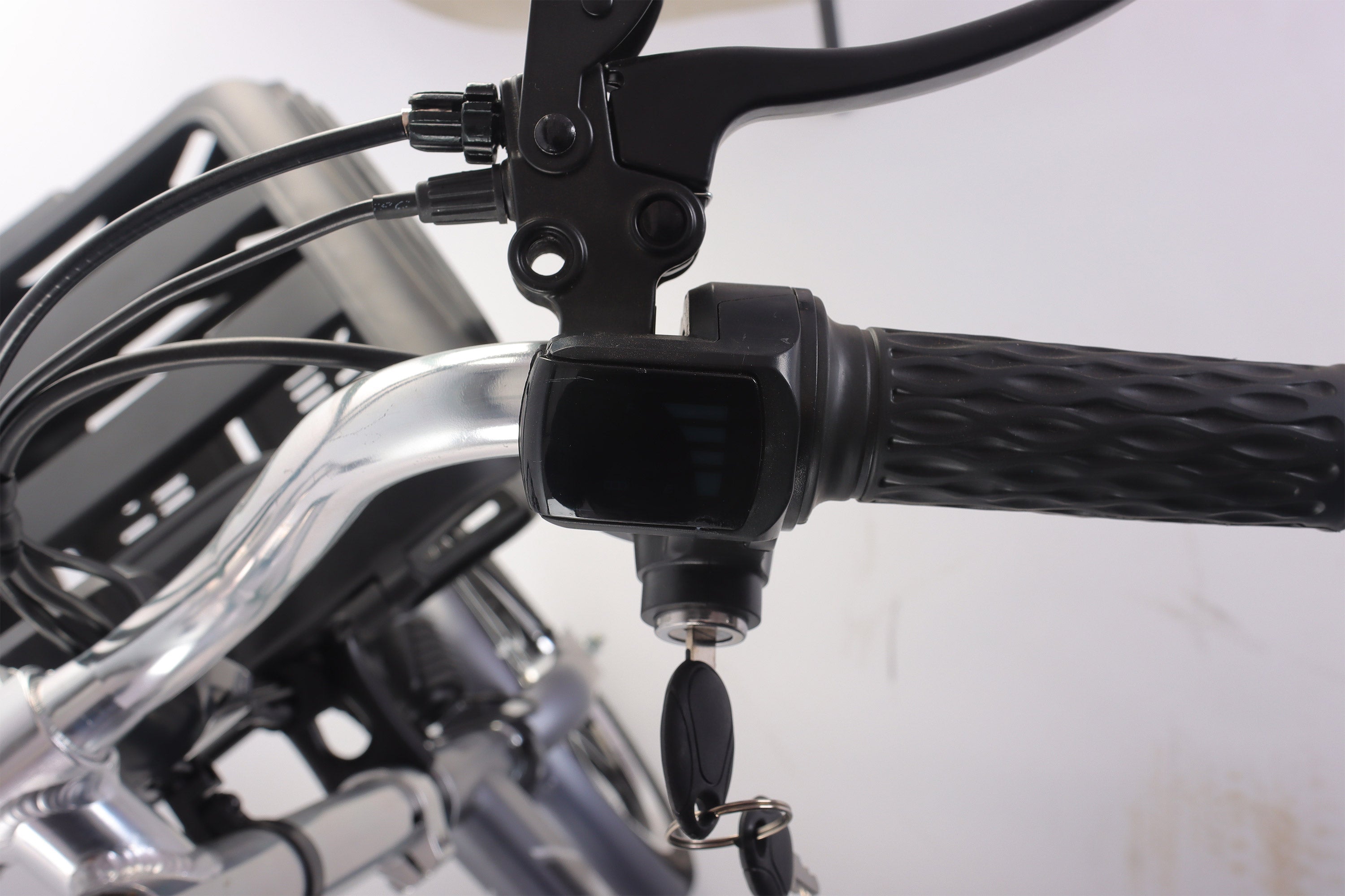 Close-up of a motorcycle handlebar with control levers and throttle grip.