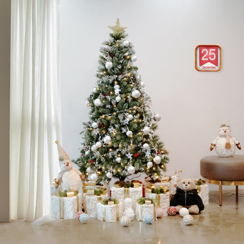 Decorated Christmas tree with ornaments and presents in a room.
