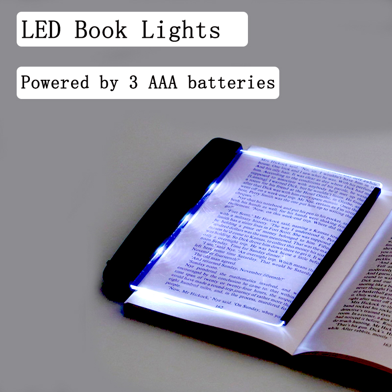 LED book light illuminating an open book on a gray background