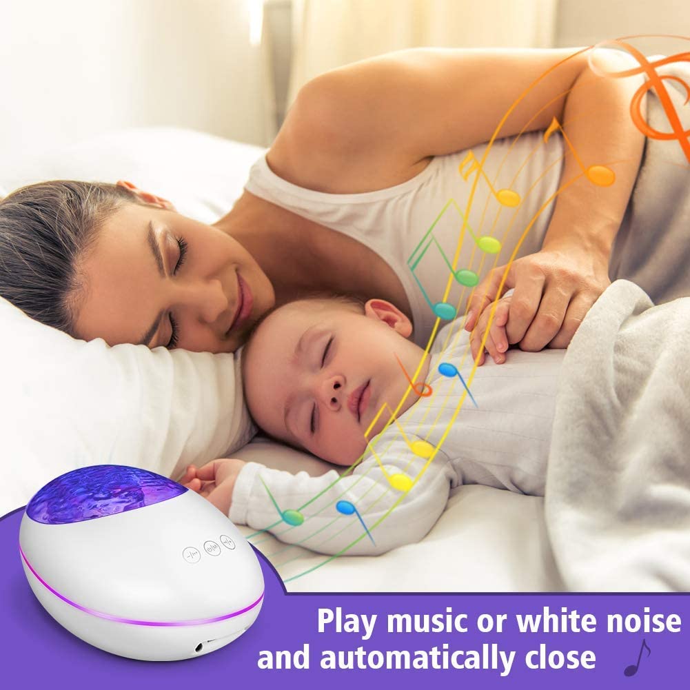Woman and child lying down with a white noise machine, surrounded by colorful lights.
