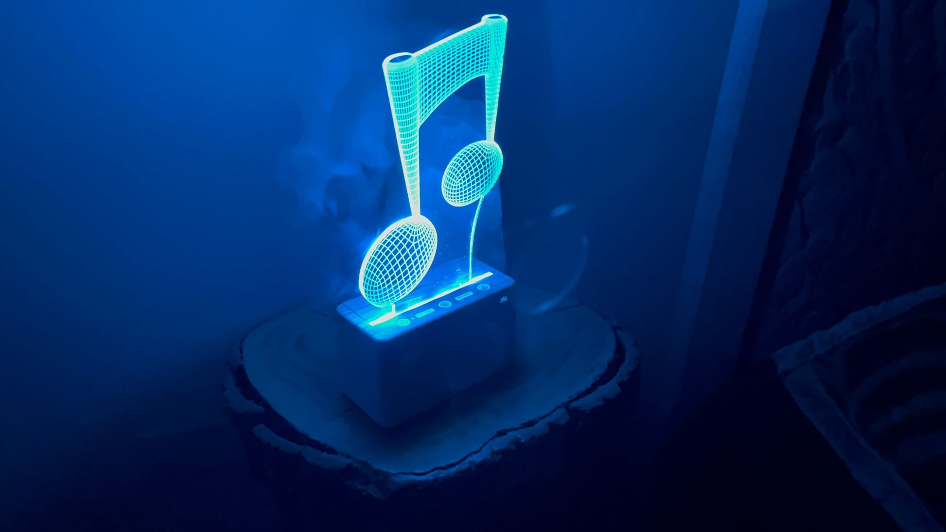 Blue LED night light shaped like a music note on a dark background