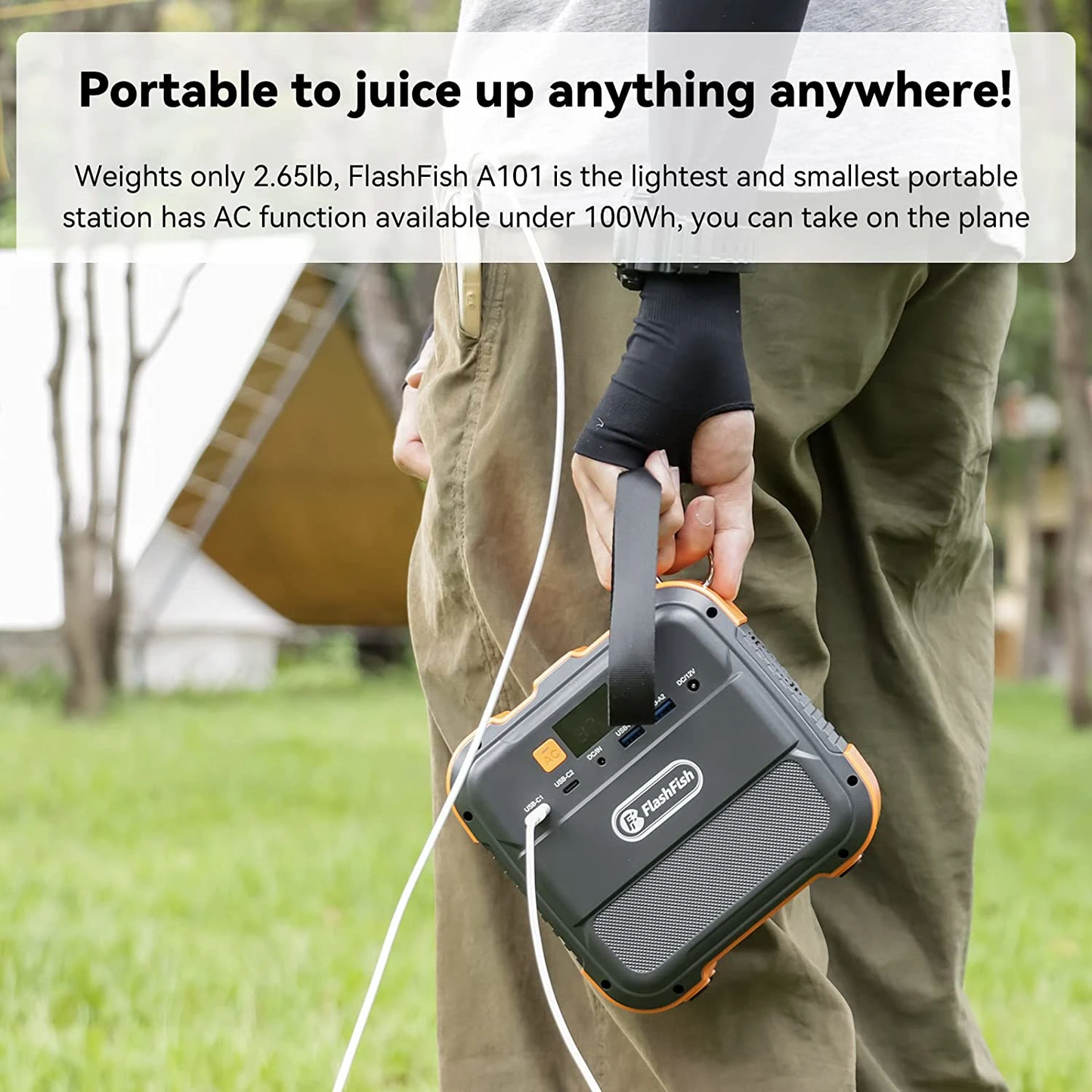 Person holding a portable power station with camping background. portable power station