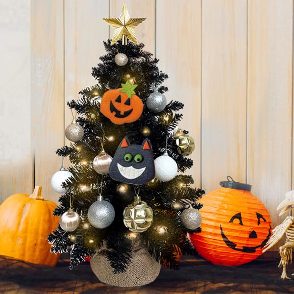 Halloween-themed Christmas tree with decorations, pumpkins, and a skeleton.