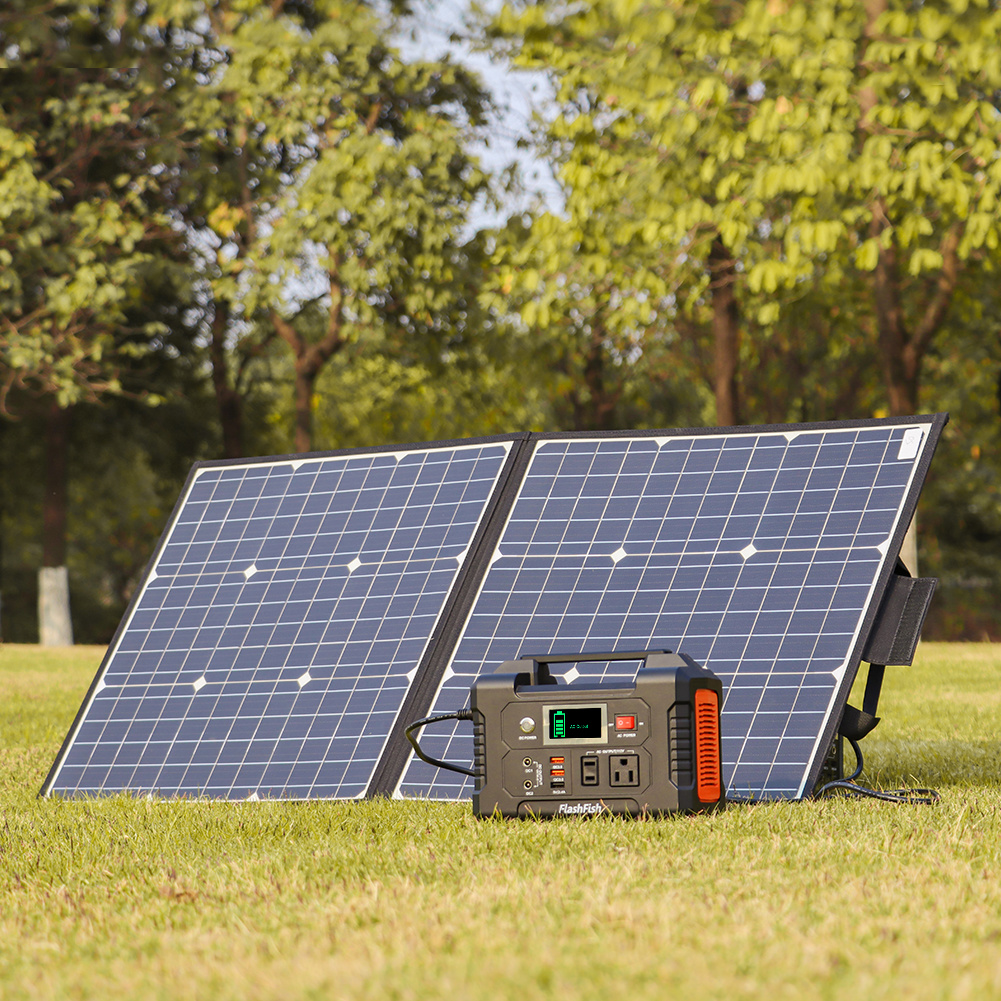 Solar panel and power station on grass with trees in the background. portable power station for sale