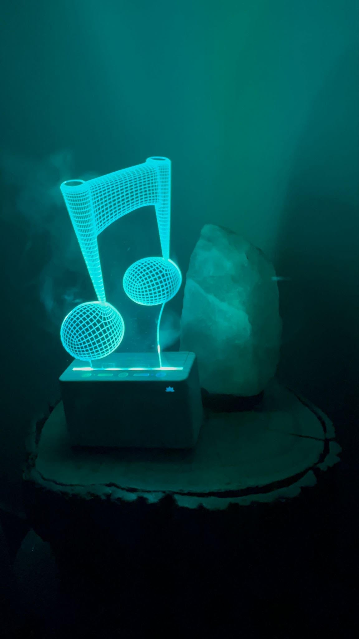 Glowing blue music note lamp on a dark background