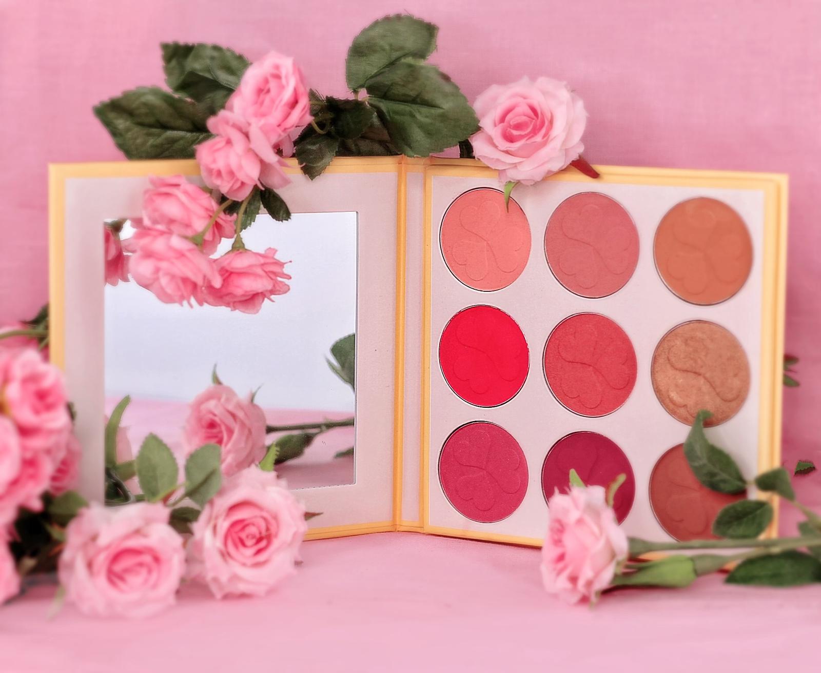 Makeup palette with pink flowers on a pink background. Best online retail store. Axis-Dynamics