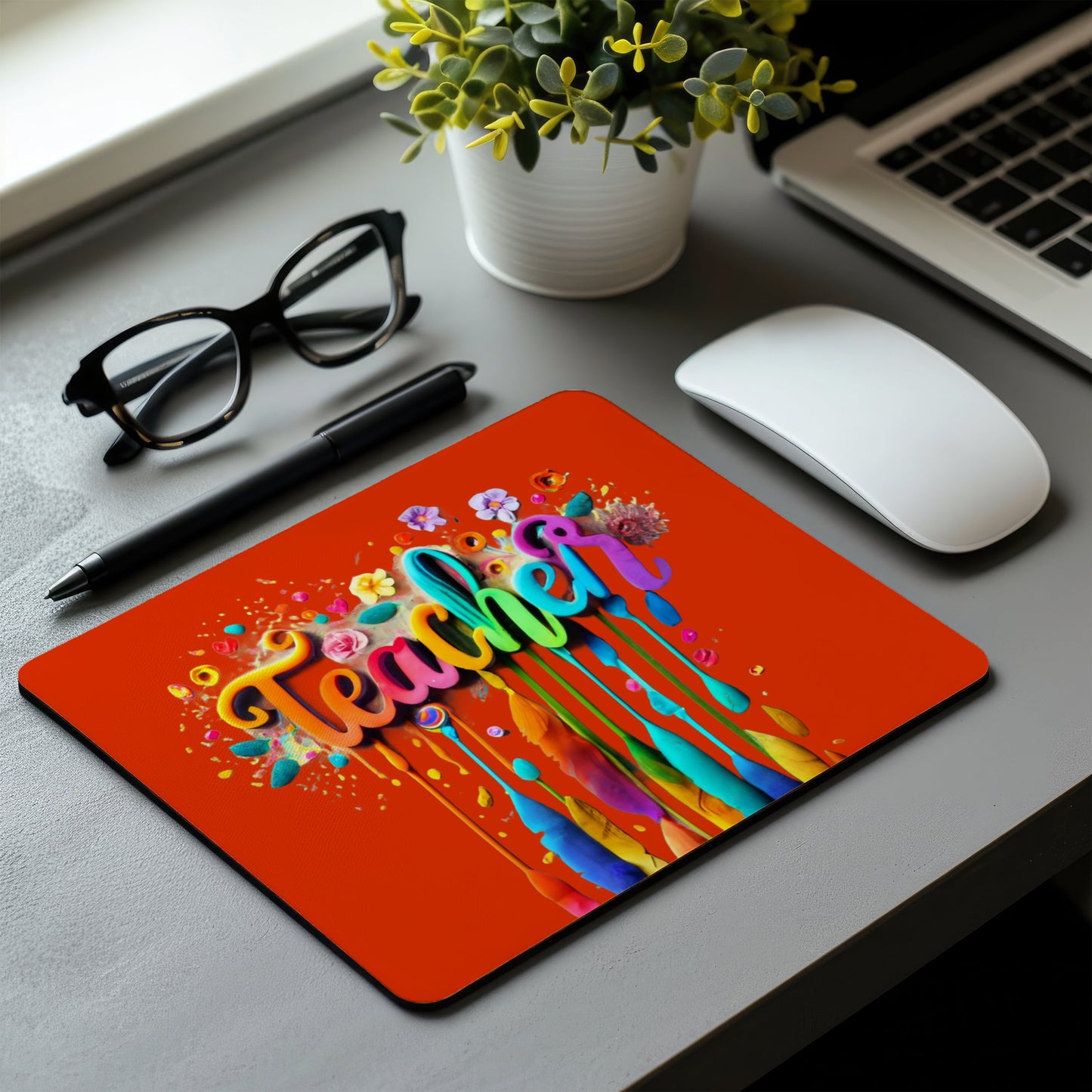 Colorful 'Teacher' mouse pad on a desk with a laptop, mouse, and glasses. magnetic switch rapid trigger gaming keyboard. Axis-Dynamics