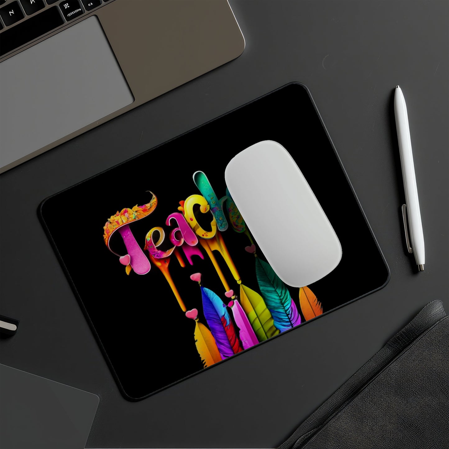 Colorful 'Teach' mouse pad on a desk with a laptop and pen. Best electronics online store near me. Axis-Dynamics