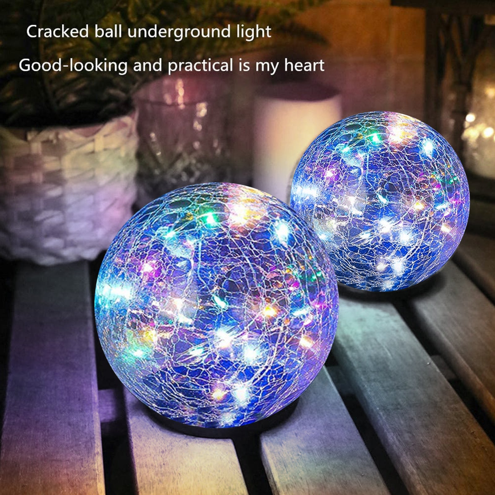 Two cracked glass balls with LED lights on a wooden surface.