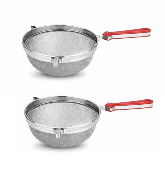 Two metal strainers with red handles on a white background