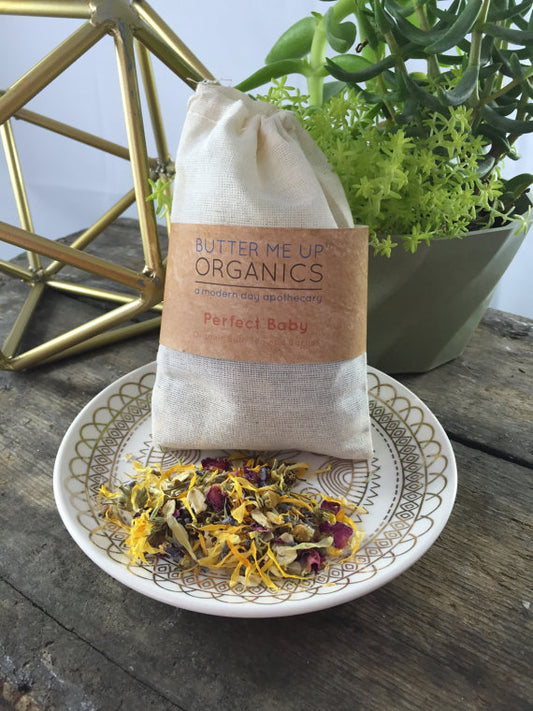 Butter Me Up Organics packaging on a decorative plate with plants in the background. Best online retail store. Axis-Dynamics
