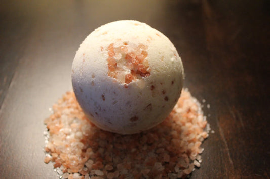 Bath bomb on a bed of pink Himalayan salt crystals. Best online retail store. Axis-Dynamics