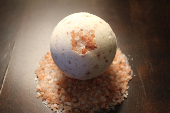 Bath bomb on a bed of pink Himalayan salt crystals. Best online retail store. Axis-Dynamics