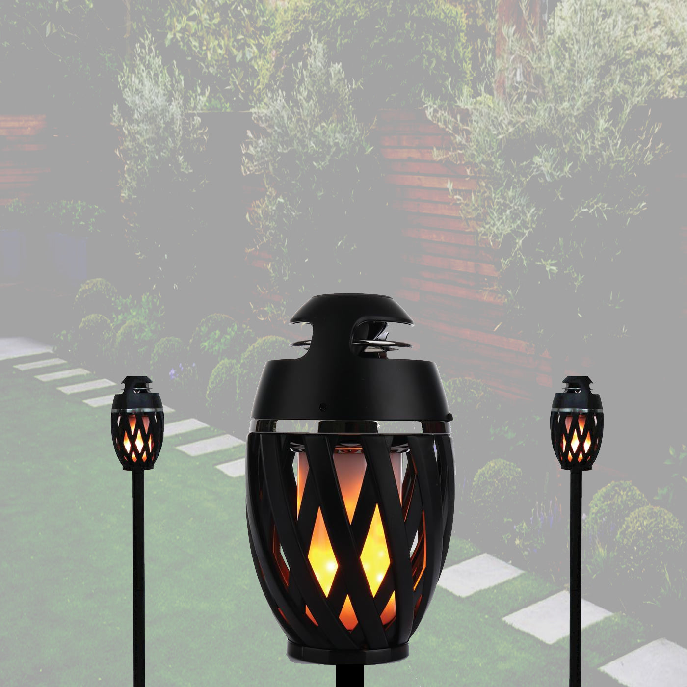 Black outdoor torches with flame effect on a garden path background