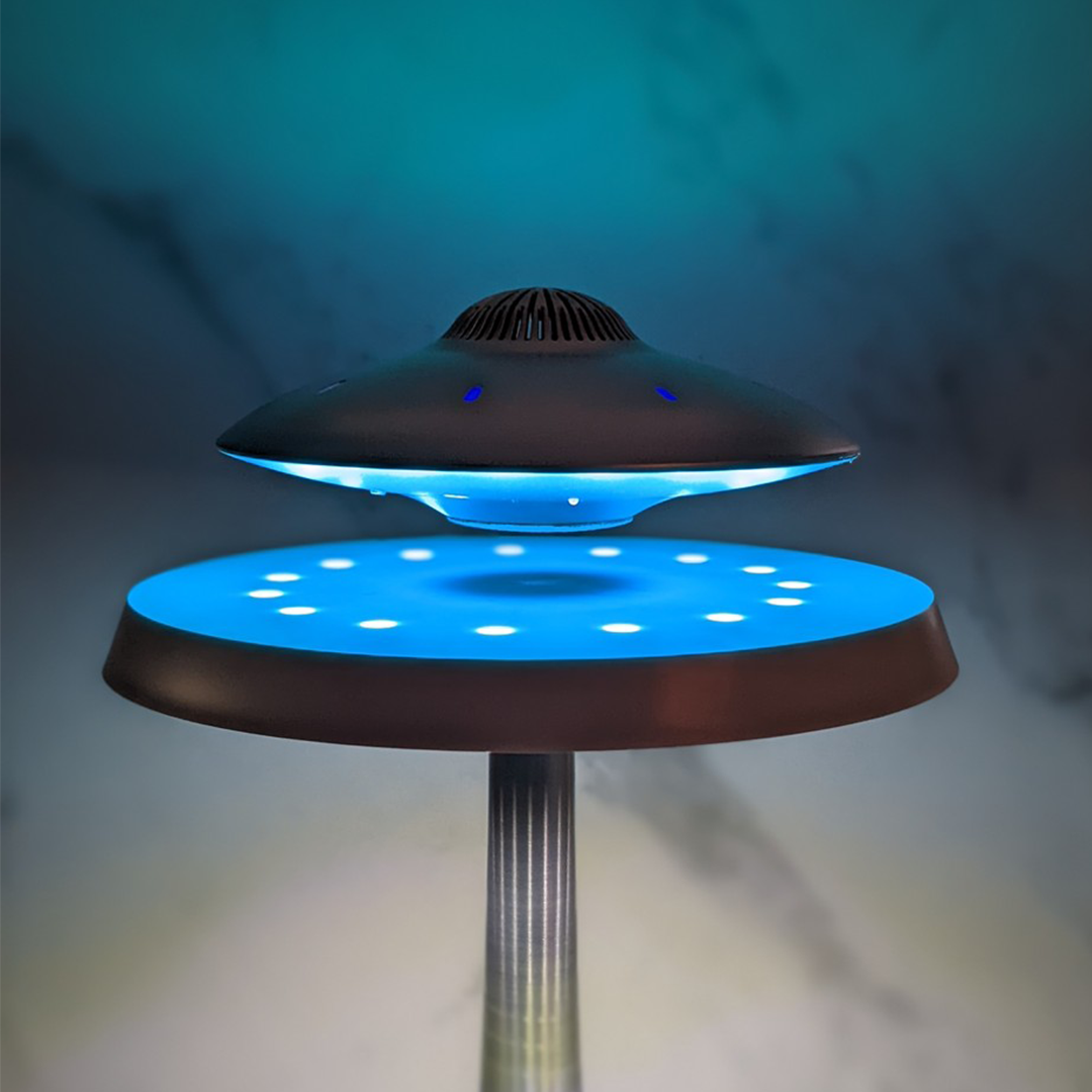 UFO-shaped lamp with blue light on a dark background